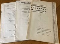 Three 1949 juvenile delinquency pamphlets laid flat on a wooden surface, with titles visible.