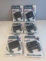 Five GPX Bass Boost portable cassette players in original blister packaging, showing front view of packaging and earphones included.