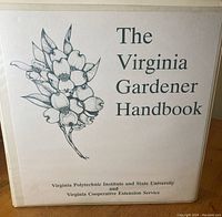 Front cover of the white three-ring binder titled 'The Virginia Gardener Handbook' with botanical illustration.