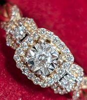 Close-up of ring face showing central diamond and surrounding halo