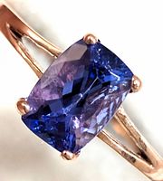 Front view of cushion-cut tanzanite showing faceting and color