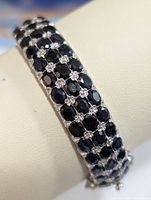 Three-quarter view of three-row sapphire bracelet on display cuff