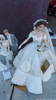 Photo of Franklin Heirloom Bride Doll showing white wedding dress, veil, hat, and bouquet