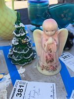 Photo showing the signed Fenton angel figurine and the green glass Christmas tree with snow accents.
