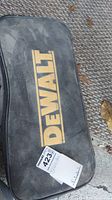 Closed black soft carrying case with large yellow Dewalt logo on top.