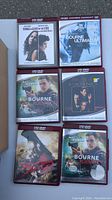 Image showing 8 HD-DVD movie cases including Bourne series, Casino, 300, and Things We Lost in the Fire.