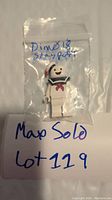 Front view of Stay Puft Lego Dimensions minifigure sealed in clear plastic bag, marked 'Dim018 stay puft'.