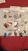 All 10 minifigures individually bagged and shown on white surface with lot number label