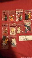 All 10 LEGO minifigures individually bagged and laid out on red background with a label 'Max Sold Lot 71'.