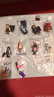 Top view of 10 individually bagged LEGO minifigures including characters from Star Wars, DC, and Town series.