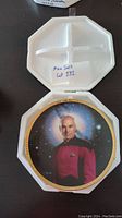 Collector plate with image of Captain Jean-Luc Picard inside protective foam case.