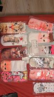 Photo showing 10 individually packaged novelty ankle socks featuring various cat faces and unicorn designs laid out in rows.