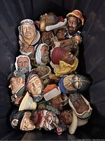 Top down view of all Bosson Heads in bin, displaying various characters and ethnicities.