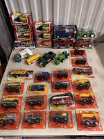 Full lot overview showing boxed and loose toy vehicles arranged on table highlighting diversity and condition.
