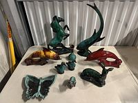 All ceramic pieces on display showing variety of animal and abstract figurines with different glazes.