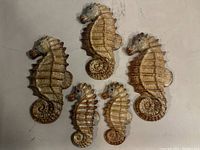 Top view of the five ceramic seahorse figurines showing size variation and detailing.