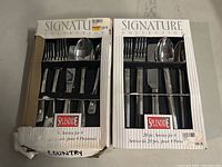Two boxed Signature Collection Splendide cutlery sets, one 20-piece set and one smaller set with some box damage.