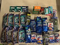 Lot of multiple Gillette disposable razors packs and razor blade packs alongside various bars of soap in original packaging