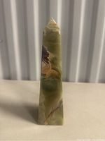 Front view of the onyx stone tower figurine showing color, texture, and shape.