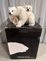 Front angle of the polar bear figurine showing adult and cub on black box.