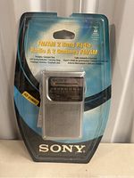 Front view of Sony FM/AM 2 Band Radio sealed in original blister pack showing product and branding.