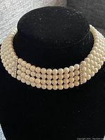 Front view of the 4 strand pearl choker showing the stacked rows and rhinestone separators.