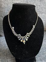 Full view of the lavaliere necklace displayed on black velvet bust highlighting overall design and length.