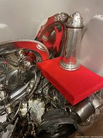 Box of various silver-plated serving items including trays and a salt shaker.