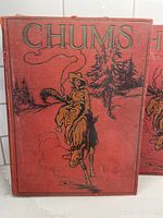 Front cover of one Chums book with red cover and cowboy on horse illustration
