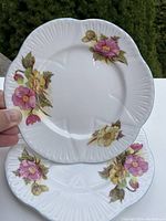 Top view of two Shelley Begonia side plates showing the pink and yellow floral Begonia design, scalloped edges and ribbed texture