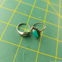 Photo showing both rings, one with turquoise stone, the other with stamped silver band