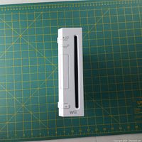 Front view of the white Nintendo Wii console showing disc slot and buttons.