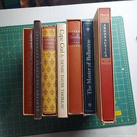Top view of seven vintage hardcover Heritage Press books showing titles and condition.