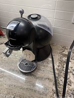 Side angle photo showing overall condition and water reservoir at back.