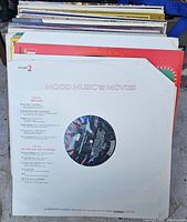 Front view of Mood Music from the Movies vinyl record in a plain white paper sleeve with a cutout showing the record label.
