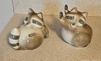 Front view of the two Fitz and Floyd ceramic raccoon bookends showing color and design