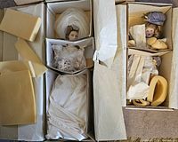 Bride and Little Bo Peep dolls in open boxes with protective packaging and tissue paper around them showing condition and completeness.