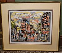 Full view of framed artist proof print showing colorful city street scene and signature.