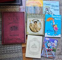 Photo of the full lot: vintage atlas, children's books including Dr. Seuss and Thomas the Tank Engine, and other collectible books