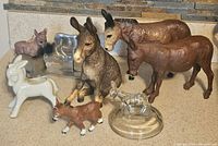 Image showing all donkey figures together on a counter, illustrating size and various materials.