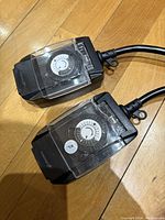 Top view of two Fosmon indoor/outdoor mechanical light timers showing dials and cords.