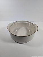Front and top views showing off-white ceramic bowl with brown speckled pattern and two handles. Smooth glaze finish with no visible chips or cracks.