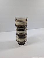 Three vintage Libbey smoky striped glass cups stacked showing size and stripes.
