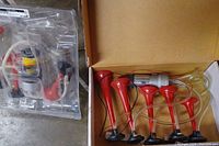 Set of five red air horns with clear tubing in cardboard box
