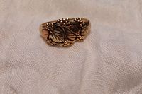 Close-up of the 10k Black Hills gold men's ring showing grape and leaf details.