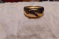 Front close-up of ring showing diagonal gemstone setting