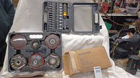 Photo showing grinding and sanding disks including flap discs and wire brush in molded case alongside a box of Scotch-Brite cleaning pads.