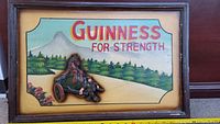 Front view of the antique GUINNESS wooden sign showing the 3D metal horse and man figure, painted nature background with 'GUINNESS FOR STRENGTH' text.