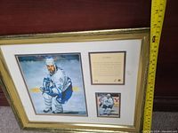 Framed 17x13 portrait-style painted photo of Doug Gilmour in Toronto Maple Leafs uniform with autograph and accompanying plaque and smaller photo within gold-tone frame and white matting.