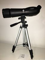 Full view of Bushmaster Spotter-206060 telescope mounted on adjustable tripod.